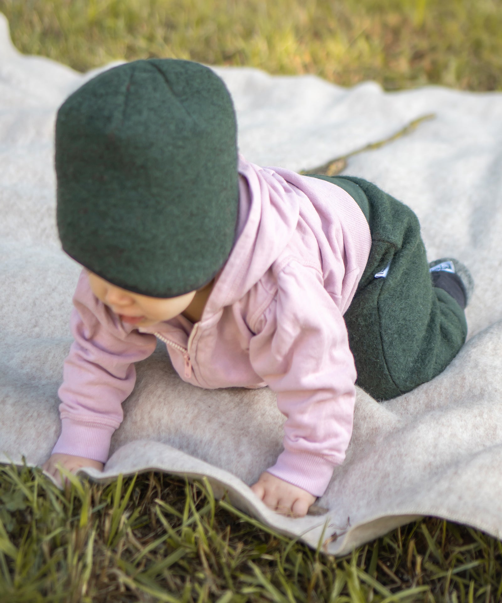Baby krabbelt auf einer Walkdecke.